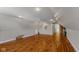 Bright bonus room featuring hardwood floors and ceiling fan at 7093 Republic Ln, Indianapolis, IN 46259