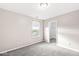 Bright bedroom with grey carpet, window, and walk-in closet at 1782 N Clearwater Dr, Greenfield, IN 46140