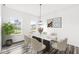 Bright dining room featuring a marble table, six chairs, and wood-look floors at 1782 N Clearwater Dr, Greenfield, IN 46140