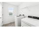 Laundry room with washer, dryer, and overhead shelving at 1782 N Clearwater Dr, Greenfield, IN 46140