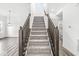 Modern staircase with dark wood railings and grey carpeting at 1782 N Clearwater Dr, Greenfield, IN 46140