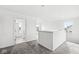 Upstairs hallway with grey carpeting and access to laundry and bedrooms at 1782 N Clearwater Dr, Greenfield, IN 46140