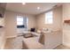 Spacious basement Gathering room featuring an L-shaped sectional sofa and large windows at 2355 W State Road 234, Fortville, IN 46040