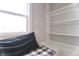 Cozy basement window seat with built-in shelves and black and white plaid cushion at 2355 W State Road 234, Fortville, IN 46040