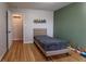 bedroom with hardwood floors and an accent wall at 2355 W State Road 234, Fortville, IN 46040