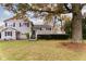Two-story house with gray siding, deck, and mature trees in the front yard at 2355 W State Road 234, Fortville, IN 46040