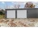 Detached two-car garage with white doors and dark gray metal siding at 2355 W State Road 234, Fortville, IN 46040