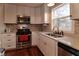 Modern kitchen with white cabinets, stainless steel appliances, and a corner sink at 2355 W State Road 234, Fortville, IN 46040
