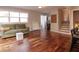 Living room with hardwood floors, green couch, and view of the stairs at 2355 W State Road 234, Fortville, IN 46040