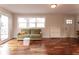 Living room with hardwood floors, green couch, and access to the deck at 2355 W State Road 234, Fortville, IN 46040