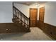 Finished basement with staircase, wood paneling, and carpet at 4256 Bending Ln, Greenwood, IN 46143