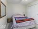 Well-lit bedroom with a queen bed and mirrored dresser at 8520 Bison Woods Ct, Indianapolis, IN 46227