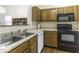 View of kitchen sink and appliances with oak cabinets at 8520 Bison Woods Ct, Indianapolis, IN 46227
