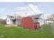 Large backyard with shed and a covered patio area at 8530 Meadowlark Dr, Indianapolis, IN 46226