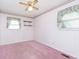 Bedroom with pink carpet, ceiling fan, and window at 8530 Meadowlark Dr, Indianapolis, IN 46226