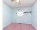 Light blue bedroom with pink carpet and ceiling fan at 8530 Meadowlark Dr, Indianapolis, IN 46226