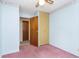 Light blue bedroom with pink carpet and ceiling fan at 8530 Meadowlark Dr, Indianapolis, IN 46226
