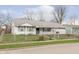 White ranch house with a carport and a fenced yard at 8530 Meadowlark Dr, Indianapolis, IN 46226