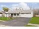 Front view of a ranch home with a long driveway at 8530 Meadowlark Dr, Indianapolis, IN 46226