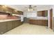 Kitchen with wood cabinets, brick backsplash, and tile floor at 8530 Meadowlark Dr, Indianapolis, IN 46226