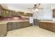 Kitchen with wood cabinets, brick backsplash, and tile floor at 8530 Meadowlark Dr, Indianapolis, IN 46226