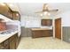 View of retro kitchen with wood cabinets and tile floor at 8530 Meadowlark Dr, Indianapolis, IN 46226