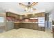 Kitchen with wood cabinets, brick backsplash, and tile floor at 8530 Meadowlark Dr, Indianapolis, IN 46226
