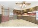Kitchen with wood cabinets and brick accent wall at 8530 Meadowlark Dr, Indianapolis, IN 46226
