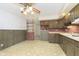 Kitchen with wood cabinets, brick backsplash, and tile floor at 8530 Meadowlark Dr, Indianapolis, IN 46226