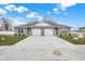 New gray duplex with a two-car garage and well-maintained lawn at 1501 Coen Ct, Columbus, IN 47201