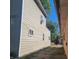 Side view of the house showcasing its light-brown siding and a glimpse of the neighboring property at 2845 Forest Manor Ave, Indianapolis, IN 46218