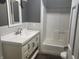 Updated bathroom with a white vanity, shower/tub combo, and gray walls at 306 E Cherry St, Advance, IN 46102