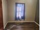Simple bedroom with dark wood flooring and a large window at 306 E Cherry St, Advance, IN 46102