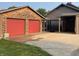 Two-car garage with red doors and additional covered parking at 306 E Cherry St, Advance, IN 46102