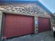 Two-car garage with wood exterior and burgundy doors at 306 E Cherry St, Advance, IN 46102