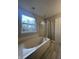 Bathroom with soaking tub, shower, and tile flooring at 3518 Birchfield Pl, Indianapolis, IN 46268