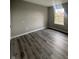 Simple bedroom with large window and wood-look flooring at 3518 Birchfield Pl, Indianapolis, IN 46268