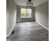 Bright dining room with gray walls, wood-look floors, and a modern light fixture at 3518 Birchfield Pl, Indianapolis, IN 46268
