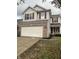 Two-story house with tan siding, brick bottom, and a two-car garage at 3518 Birchfield Pl, Indianapolis, IN 46268