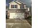 Two-story house with tan siding, brick bottom, and a two-car garage at 3518 Birchfield Pl, Indianapolis, IN 46268