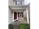 Inviting front porch with a red door and brick accents at 3518 Birchfield Pl, Indianapolis, IN 46268