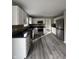 Modern kitchen with white cabinets, granite countertops, and stainless steel appliances at 3518 Birchfield Pl, Indianapolis, IN 46268