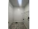 Clean laundry room with tile floor and built-in shelving at 3518 Birchfield Pl, Indianapolis, IN 46268