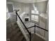 Elegant staircase with black and white railings at 3518 Birchfield Pl, Indianapolis, IN 46268