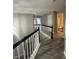 Upper-level landing with hardwood floors and black railing at 3518 Birchfield Pl, Indianapolis, IN 46268