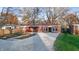 Brick house with red roof, landscaped yard, and gravel driveway at 3745 N Kercheval Dr, Indianapolis, IN 46226