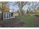 Backyard with shed, large tree, and small greenhouse at 3745 N Kercheval Dr, Indianapolis, IN 46226
