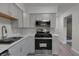 Modern kitchen with gray cabinets and stainless steel appliances at 3745 N Kercheval Dr, Indianapolis, IN 46226
