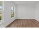 Simple bedroom with hardwood floors and a large window at 4973 Amber Crest Dr, Brownsburg, IN 46112