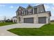 Two-story house with gray siding, brick accents, and a three-car garage at 4973 Amber Crest Dr, Brownsburg, IN 46112